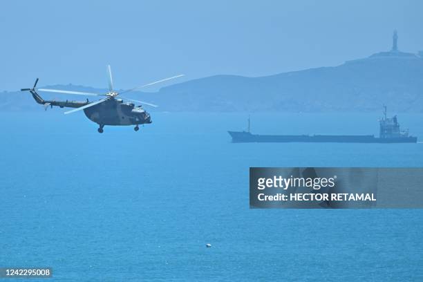 Chinese military helicopter flies past Pingtan island, one of mainland China's closest point from Taiwan, in Fujian province on August 4 ahead of...