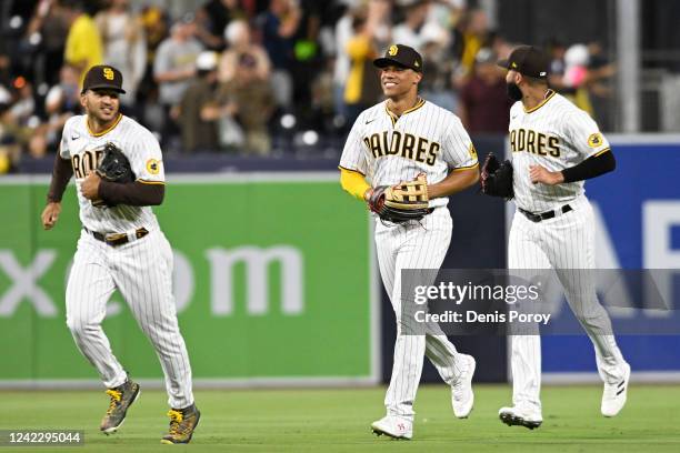 Trent Grisham, Juan Soto and Nomar Mazara celebrate a 9-1 win over Colorado Rockies on August 3, 2022 at Petco Park in San Diego, California.