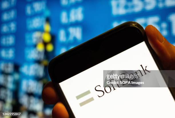 In this photo illustration, the Japanese multinational holding conglomerate SoftBank logo is displayed on a smartphone screen.