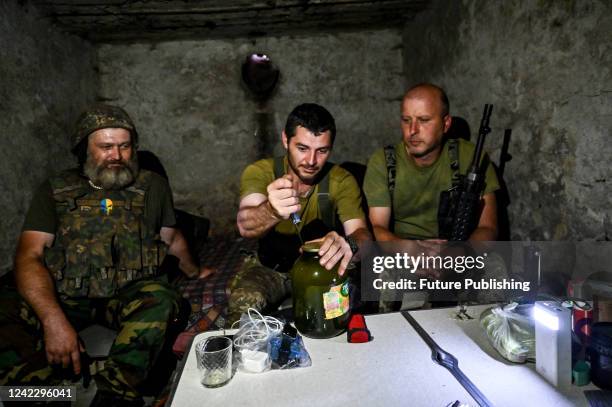 Servicemen of a Territorial Defence battalion take cover in a basement from shelling by Russian troops, Zaporizhzhia Region, southeastern Ukraine....