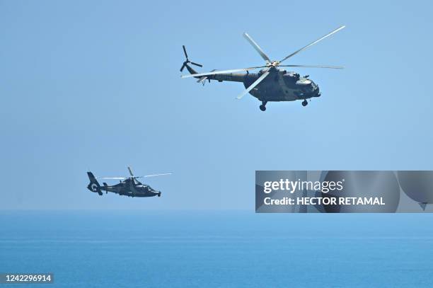 Chinese military helicopters fly past Pingtan island, one of mainland China's closest point from Taiwan, in Fujian province on August 4 ahead of...