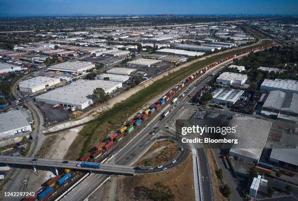 Freight containers alongside commercial buildings and warehouses, with roofs painted white to reflect the heat, in Compton, California, US, on...