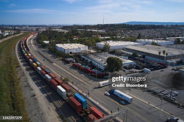 Freight containers alongside commercial buildings and warehouses, with roofs painted white to reflect the heat, in Compton, California, US, on...