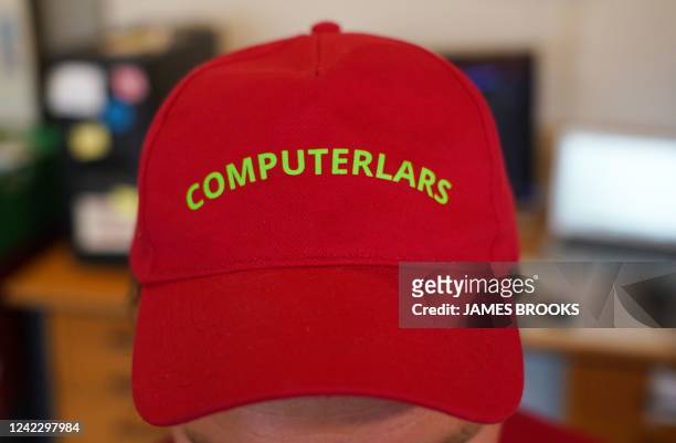 Asker Bryld Staunaes, member of artists collective Computer Lars, poses with a "Computer Lars" branded cap in Aarhus, Denmark, on August 3, 2022. - A...