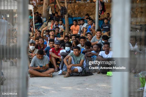 Migrants gather inside the so-called "Hotspot" operational facility, containing over 1,500 people, on August 4, 2022 in Lampedusa, Italy. The Italian...