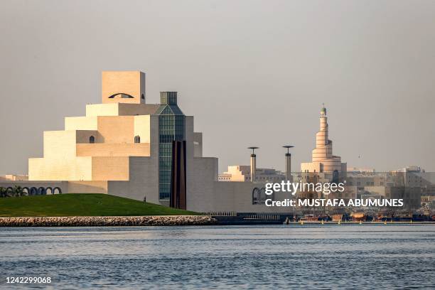 This picture taken early on August 4, 2022 shows a view of Qatar's Museum of Islamic Art and the spiral minaret at the mosque of the Abdullah bin...