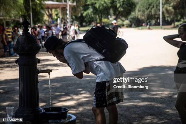 Visitor cools their face at a drinking fountain at Ciutadella Park, a designated climatic refuge, part of Barcelonas Climate Shelter Network , where...