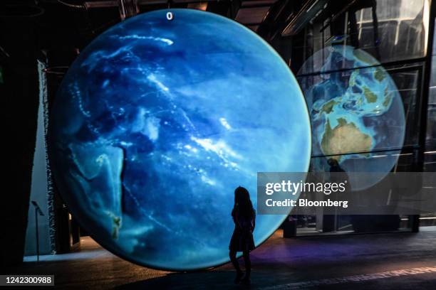 Child inspects a large-scale projection of planet earth at the Museum of Natural Sciences of Barcelona, a designated climatic refuge, part of...