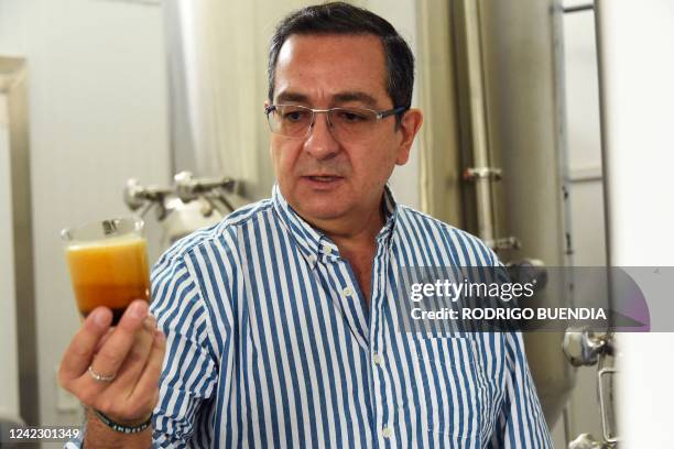 Ecuadorian scientist Javier Carvajal shows a glass of craft beer made with a 400-year-old yeast that Carvajal resurrected in a laboratory at his...