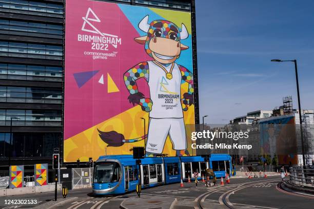 Tram passes signage depicting official mascot Perry the bull promoting the proud host city of the Birmingham 2022 Commonwealth Games in the city...