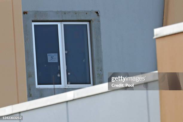 Sign reading hallway 3rd floor west facing and six bullet holes can be seen in a third floor window of the 1200 building, the crime scene where the...