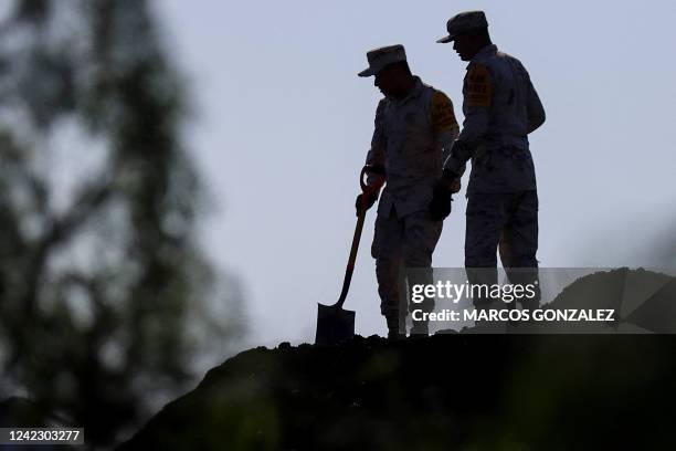 Mexican soldiers do rescue work at the coal mine where 10 miners were trapped yesterday after a collapse, in the Agujita area, Sabinas municipality,...