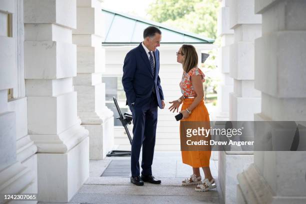 Sen. Mitt Romney talks with Sen. Kyrsten Sinema outside the U.S. Capitol August 4, 2022 in Washington, DC. Negotiations continue on the Senate budget...