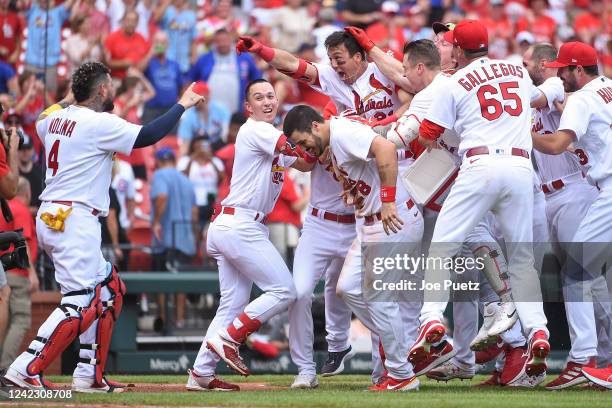 Lars Nootbaar of the St. Louis Cardinals is congratulated by teammates after hitting a walk-off single against the Chicago Cubs in the ninth inning...