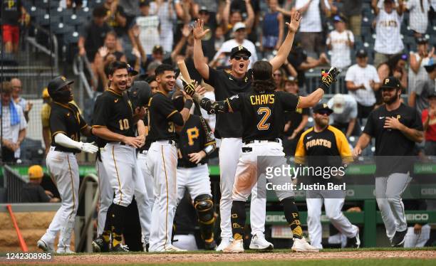 Michael Chavis of the Pittsburgh Pirates reacts with Mitch Keller after a walk-off 5-4 win over the Milwaukee Brewers during the game at PNC Park on...