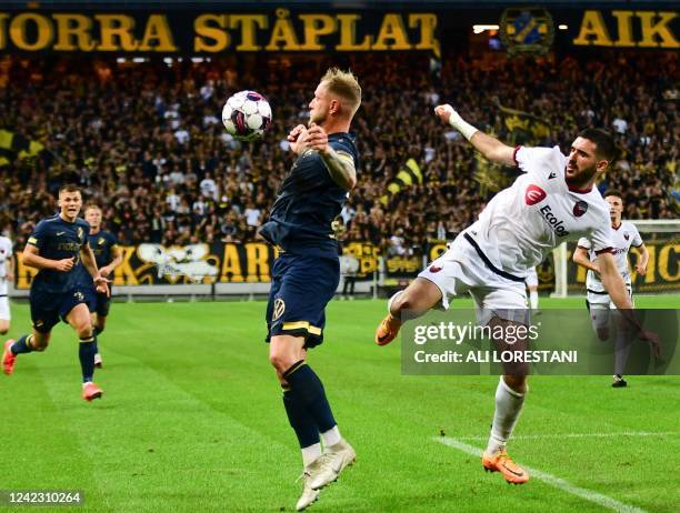 S Swedish forward John Guidetti covers the ball from Shkendija's Albanian midfielder Klisman Cake during the UEFA Europa Conference League third...