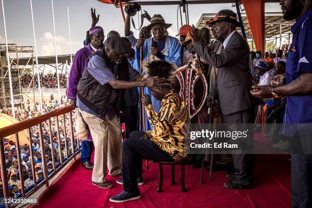 Kenya's Azimio La Umoja Party presidential candidate Raila Odinga, wearing a traditional Luo hat, takes part in a ceremony during a campaign rally in...