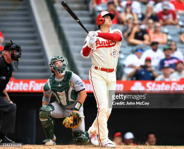 Stephen Vogt of the Oakland Athletics looks on as Shohei Ohtani of the Los Angeles Angels watches his home run leave the park in the seventh inning...