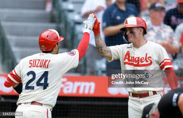Kurt Suzuki of the Los Angeles Angels is congratulated by Mickey Moniak of the Los Angeles Angels after hitting a home run in the second inning at...