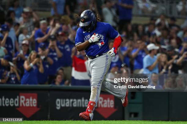 Vladimir Guerrero Jr. #27 of the Toronto Blue Jays celebrates his three-run home run as he rounds the bases against the Minnesota Twins in the eighth...