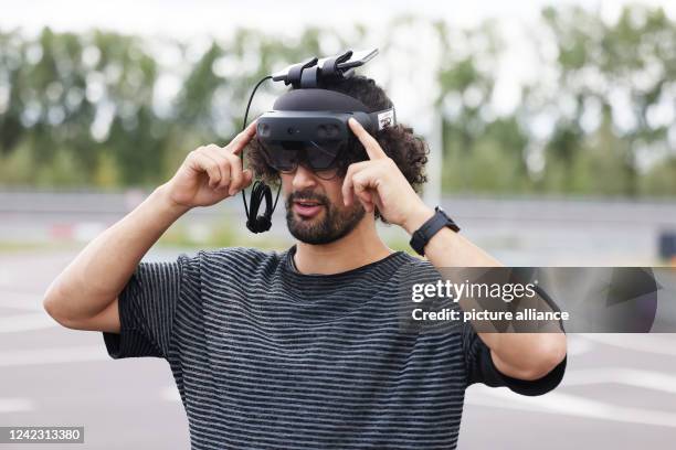 July 2022, North Rhine-Westphalia, Aldenhoven: Mohamed Azzahhafi, drone pilot at Vodafone's Innovation Lab, tests his Hololens before a drone flight....