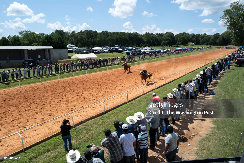 Bush Track Racing Spectators watch a quarter horse race at a bush track on July 17 ...