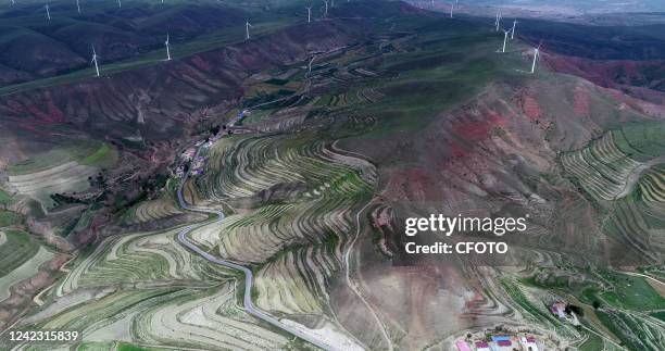 Summer terraced fields wrap around the Liupan Mountains to the top of the mountain in Yinchuan city, Northwest China's Ningxia Hui Autonomous Region,...