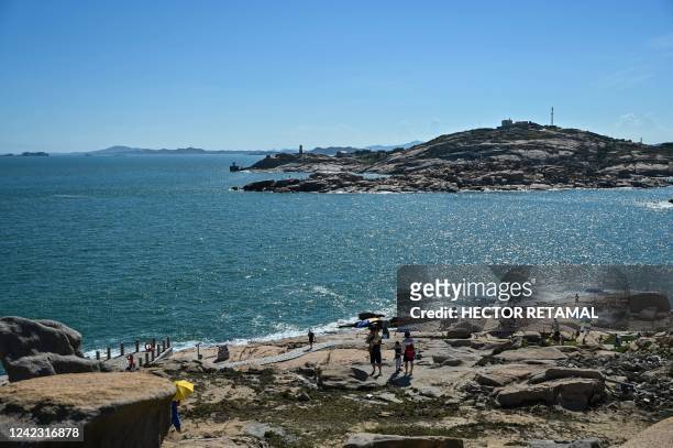 Tourists visit a scenic area on Pingtan island, one of mainland China's closest point from Taiwan, in Fujian province on August 5, 2022. - Taiwan...