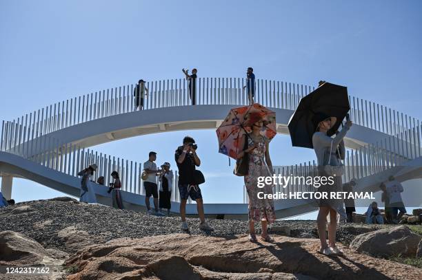 Tourists visit a scenic area on Pingtan island, one of mainland China's closest point from Taiwan, in Fujian province on August 5, 2022. - Taiwan...