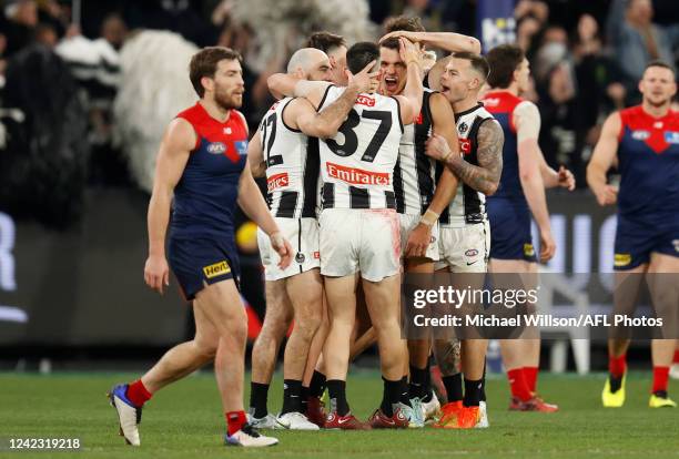 Ash Johnson of the Magpies celebrates a goal with teammates during the 2022 AFL Round 21 match between the Melbourne Demons and the Collingwood...