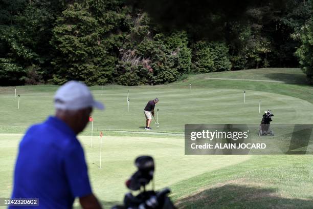 People play golf at the Rochefort casttle golf in Rochefort-en-Yvelines near Paris on August 5, 2022. - Water restrictions have already been ordered...