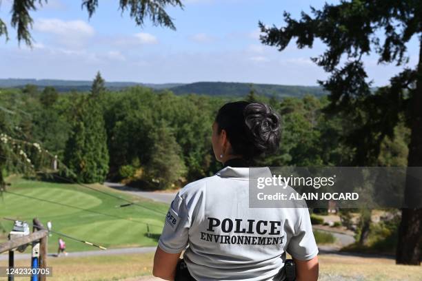 Member of the environmental police inspects a golf course in Rochefort-en-Yvelines near Paris on August 5, 2022. - Water restrictions have already...