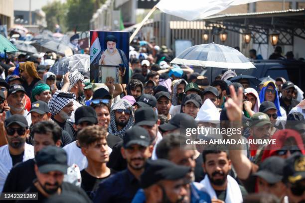 Supporters of Shiite cleric Muqtada al-Sadr gather outside the Iraqi parliament in the Green Zone in the capital Baghdad, on the seventh day of...
