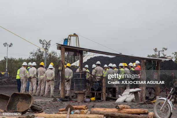 Workers of the Mexican Federal Electricity Commission do rescue work at the coal mine where 10 miners were trapped Wednesday after a collapse, in the...