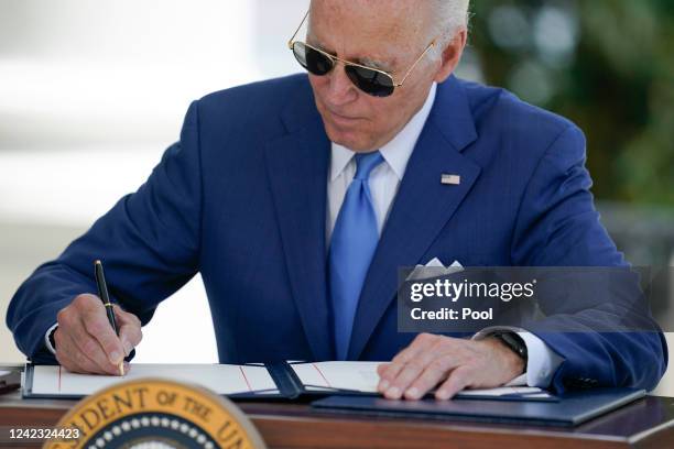 President Joe Biden signs two bills aimed at combating fraud in the COVID-19 small business relief programs at the White House on August 5, 2022 in...