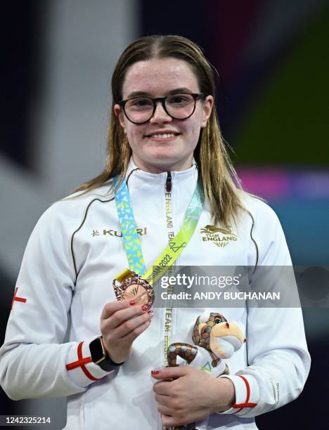 Bronze medallist England's Amy Rollinson pose during the presentation ceremony for the women's 1m springboard diving finals on day eight of the...