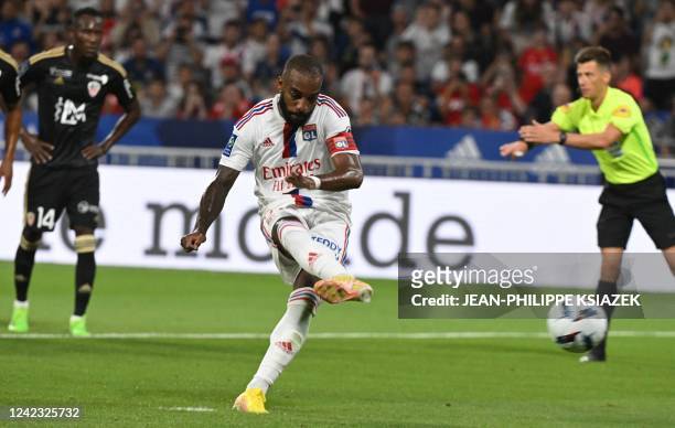 Lyon's French forward Alexandre Lacazette kicks to score his team's second goal on a penalty during the French L 1 football match between Olympique...