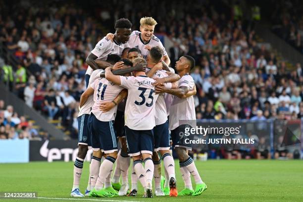 Arsenal's Brazilian midfielder Gabriel Martinelli celebrates with teammates after scoring the opening goal in the English Premier League football...