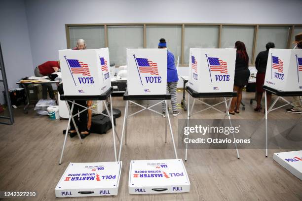 Supervisor of Elections workers and volunteers work to assemble voting booths at the Robert L. Gilder Elections Service Center on August 5, 2022 in...