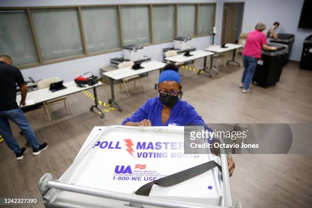 Jessie Finlayson, a volunteer election worker unloads voting booths for assembly at the Robert L. Gilder Elections Service Center on August 5, 2022...