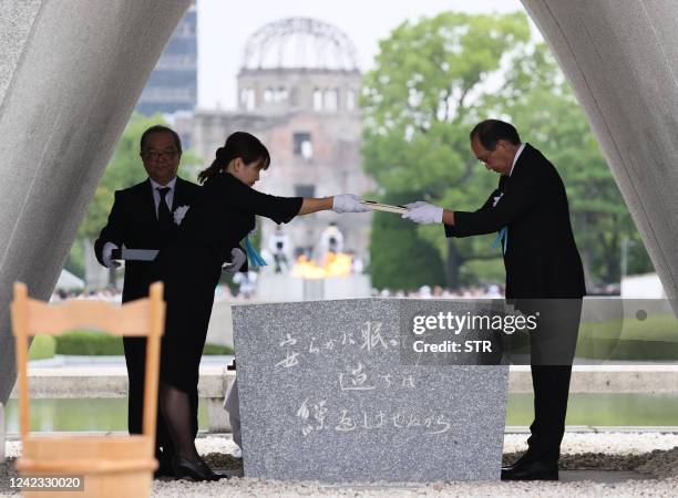 Hiroshima Mayor Kazumi Matsui and representatives of the bereaved families enshrine the list of the atomic bomb victims at the Cenotaph during the...