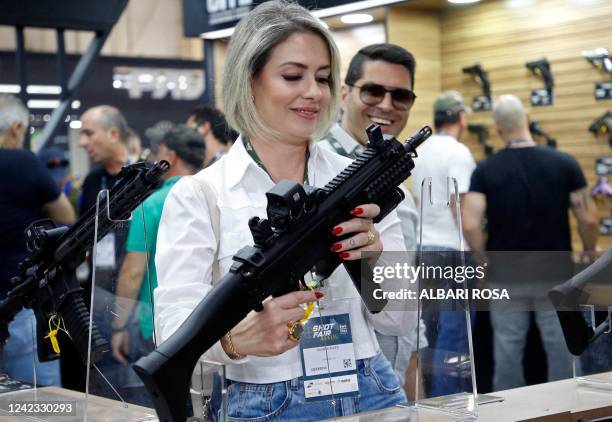 Visitor holds a weapon during the Shot Fair Brasil, an arms exhibition held at the Expoville Conventions and Exhibitions Centre in Joinville, Santa...