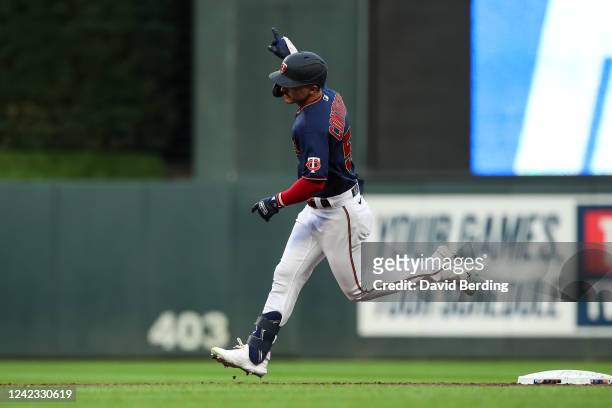 Mark Contreras of the Minnesota Twins celebrates as he rounds the bases on his solo home run against the Toronto Blue Jays in the third inning of the...