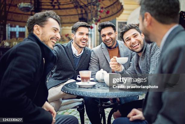 group of friends are talking and having fun in a cafeteria - indian colleague stock pictures, royalty-free photos & images