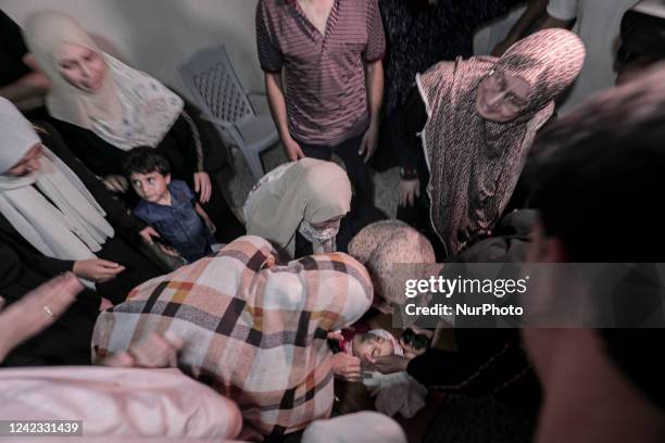 Palestinians attend the funeral of Alaa Qaddum who was killed in an Israeli air strike along with another Palestinians on August 5, 2022.