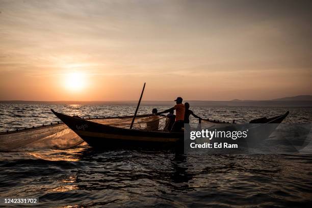 Men fish using a large net on Lake Victoria on August 5, 2022 in Kisumu, Kenya. The fishing industry, which has been negatively impacted by climate...
