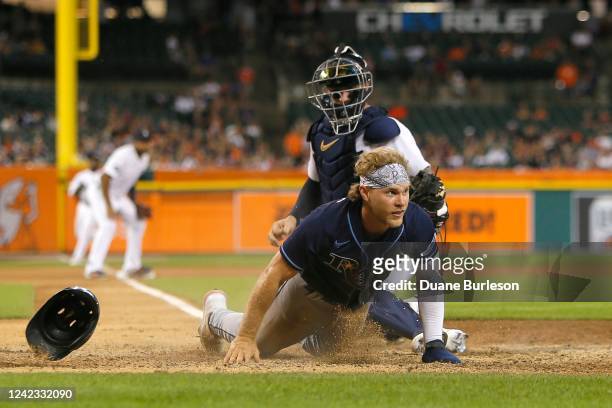 Taylor Walls of the Tampa Bay Rays scores past catcher Tucker Barnhart of the Detroit Tigers on a double by Brandon Lowe during the ninth inning at...