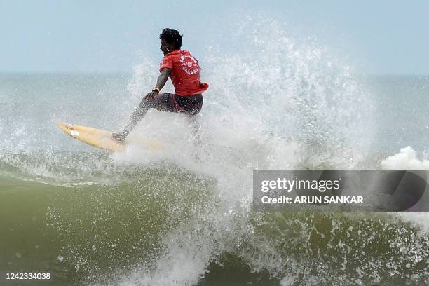 Man surfs during the annual Covelong Point Classic Surf festival at Kovalam in the outskirts of Chennai on August 6, 2022.