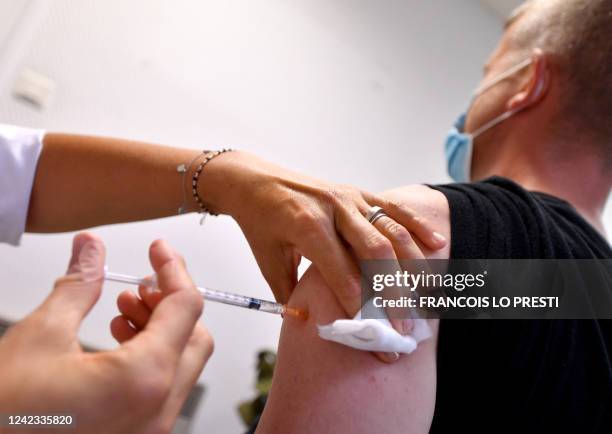 Man receives a dose of an Imvanex vaccine used to protect against Monkeypox virus at a Monkeypox vaccination site inside the Centre gratuit...