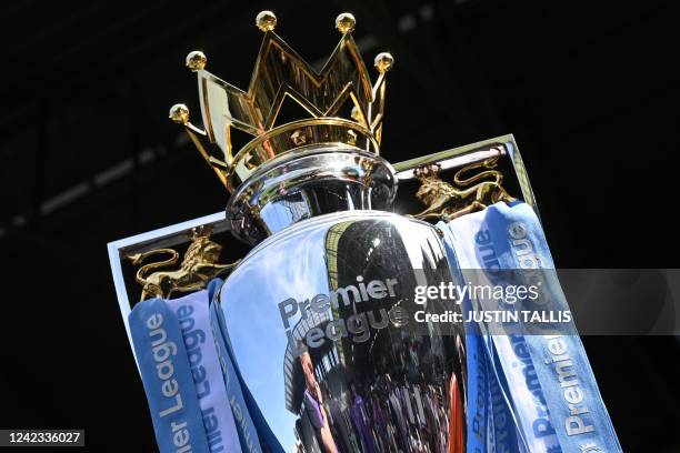 The Premier League trophy is seen on display pitch-side ahead of the English Premier League football match between Fulham and Liverpool at Craven...